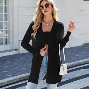 Detalle de moda de un cárdigan largo de punto negro para mujer en un entorno urbano