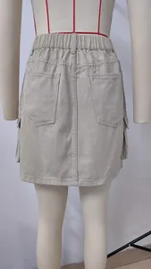 Back view detail of washed khaki denim cargo skirt featuring elastic waist and pockets