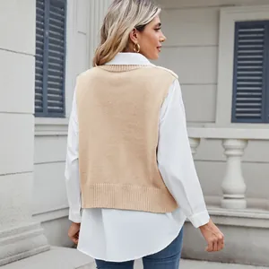 Back view of a casual beige knit vest styled over a white long-sleeve shirt