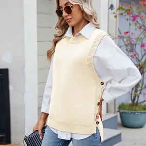 Detailed close-up of side button decorations and slit on a cream knit sweater vest