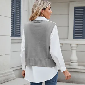 Rear view of a stylish grey V-neck knitted sweater vest layered over a crisp white shirt