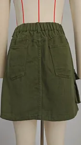 Back view of army green washed denim cargo mini skirt with elastic waist and pockets.