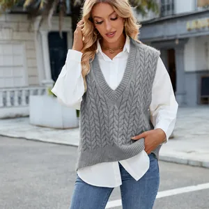Macro detail of vintage grey cable knit V-neck sleeveless sweater vest on model