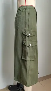 Detailed side view of olive green cargo midi skirt with elastic waist and pockets