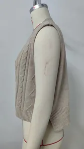 Side profile detail of a beige V-neck cable knit sweater vest displayed on a mannequin
