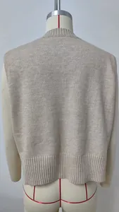 Back view of a minimalist loose-fit beige knitted V-neck sweater vest for women