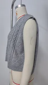 Side profile detail of a grey cable-knit V-neck sleeveless sweater vest on a white mannequin