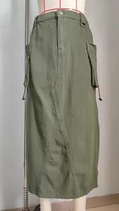 Detailed close-up of an olive green cargo midi skirt with functional drawstring pockets.