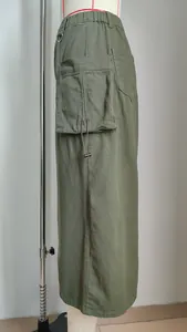 Detailed side view of green retro denim cargo midi skirt with large pocket and drawstring