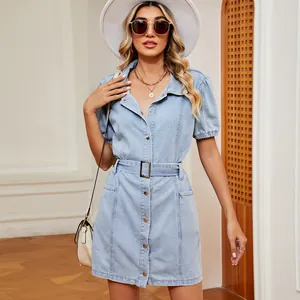 Detail view of light blue washed denim shirt dress with adjustable waist belt and buttons
