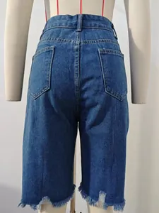 Back view of women's blue denim shorts with frayed hem and distressed ripped details