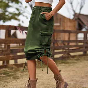 Detailed view of a dark green denim cargo midi skirt with drawstring hem and side pockets.