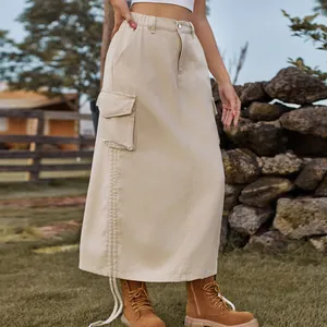Detail of khaki denim cargo maxi skirt with large side pockets and drawstring hem.