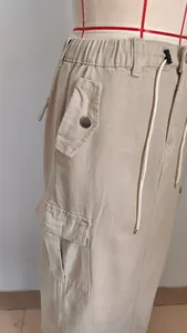 Detail of khaki cargo skirt with drawstring waist and side utility pockets