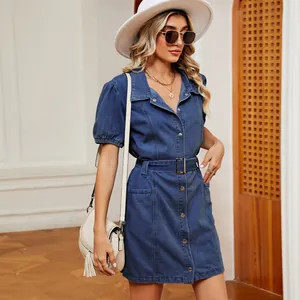 Stylish women's blue wash denim button-down mini dress with puff sleeves and waist belt.