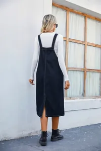 Detailed rear view of a stylish dark blue denim overall midi dress with split hem