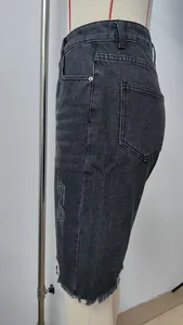 Detailed side view of black distressed denim shorts featuring raw fringe hem on mannequin