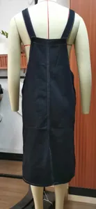 Detailed back view of a classic navy blue denim overall midi dress on a store mannequin