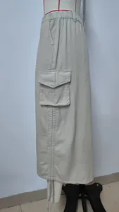 Close-up detail view of a beige denim cargo skirt featuring a large side flap pocket