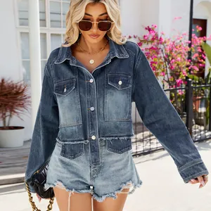 Close-up detail of women's trendy washed blue short denim jacket with raw edges.