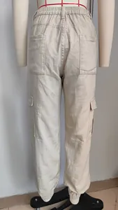 Detailed back view of beige women's denim cargo pants with elastic waist and jogger cuffs