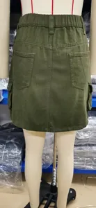 Detailed back view of an olive green denim cargo skirt featuring elastic waist and pockets