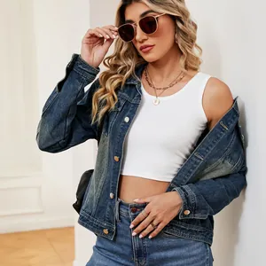 Female model posing in casual washed blue denim jacket and white tank top outfit