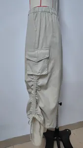 Detailed view of khaki cargo skirt with ruched drawstring and large side pocket.