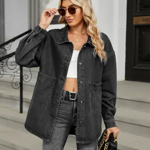 Detailed shot of a women's oversized washed black denim jacket with front pockets