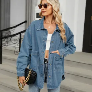 Close-up detail of a light blue washed oversized denim jacket featuring large front pockets
