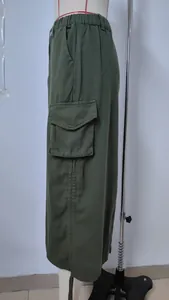 Close-up of army green cargo midi skirt featuring a functional side flap pocket.