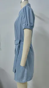 Close-up side view of a light blue denim dress with short puff sleeves and a waist belt.