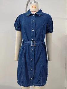 Front view detail of a washed denim midi dress with a belt on a mannequin