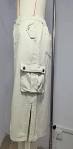 Close-up detail of cream women cargo midi skirt showing functional side pocket and high slit