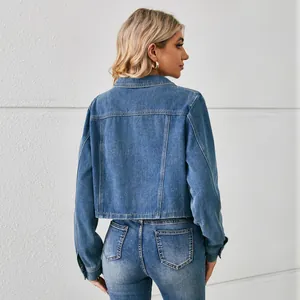 Back view of a trendy short-waisted washed denim jacket for women in blue color.