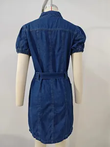 Detailed back view of dark blue wash denim dress featuring puff sleeves and waist belt