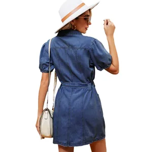 Back view of a washed blue denim midi dress with a waist belt and puff sleeves.