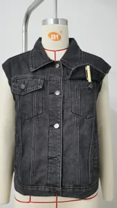 Close-up of a black washed denim vest with chest pocket detail displayed on a mannequin.