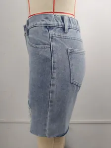 Side view of distressed light blue denim shorts on a mannequin with raw hem details