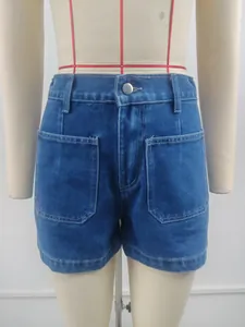 Front view detail of washed blue denim shorts with large patch pockets and mid-waist.