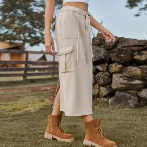 Detailed view of a beige washed cargo denim midi skirt featuring a large utility pocket