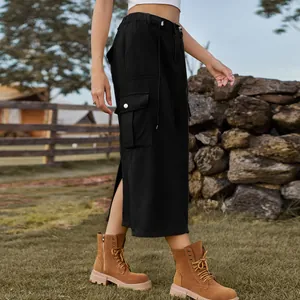 Detail view of washed black cargo denim midi skirt with side slit and pockets