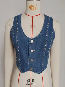 Detail shot of a retro washed denim vest featuring metallic studs and a V-neck cut