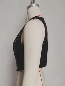 Detailed side view of vintage black washed denim vest with silver studs on mannequin dress form