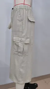 Detail view of khaki cargo denim skirt showing drawstring waist and functional side pockets