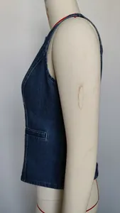 Detailed side profile of a dark wash denim vest with white contrast stitching on a mannequin.