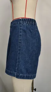 Side profile detail of high-waisted denim shorts with an elastic waistband on mannequin