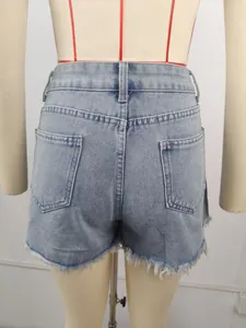Back view detail of light blue high-waisted denim shorts with stylish frayed hems
