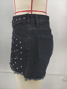 Side view of black distressed denim shorts with decorative rhinestone embellishments