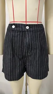 Close-up detail of high-waisted striped denim shorts featuring stylish white button accents
